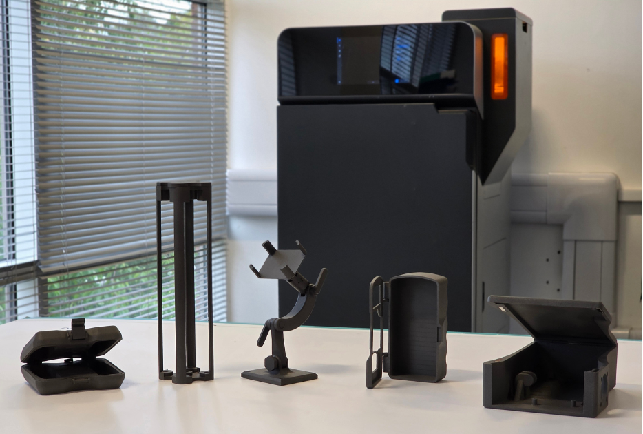 5 Nylon 12 parts in front of Fuse 1+ 30W SLS printer